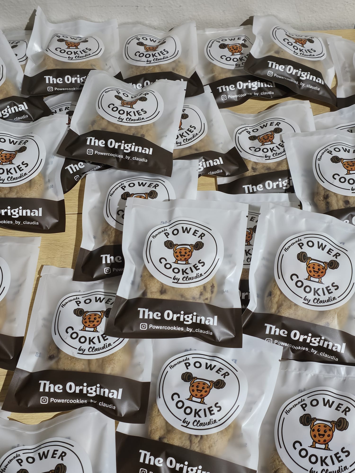 Multiple small cookie packages with a bear logo and text, arranged on a surface.