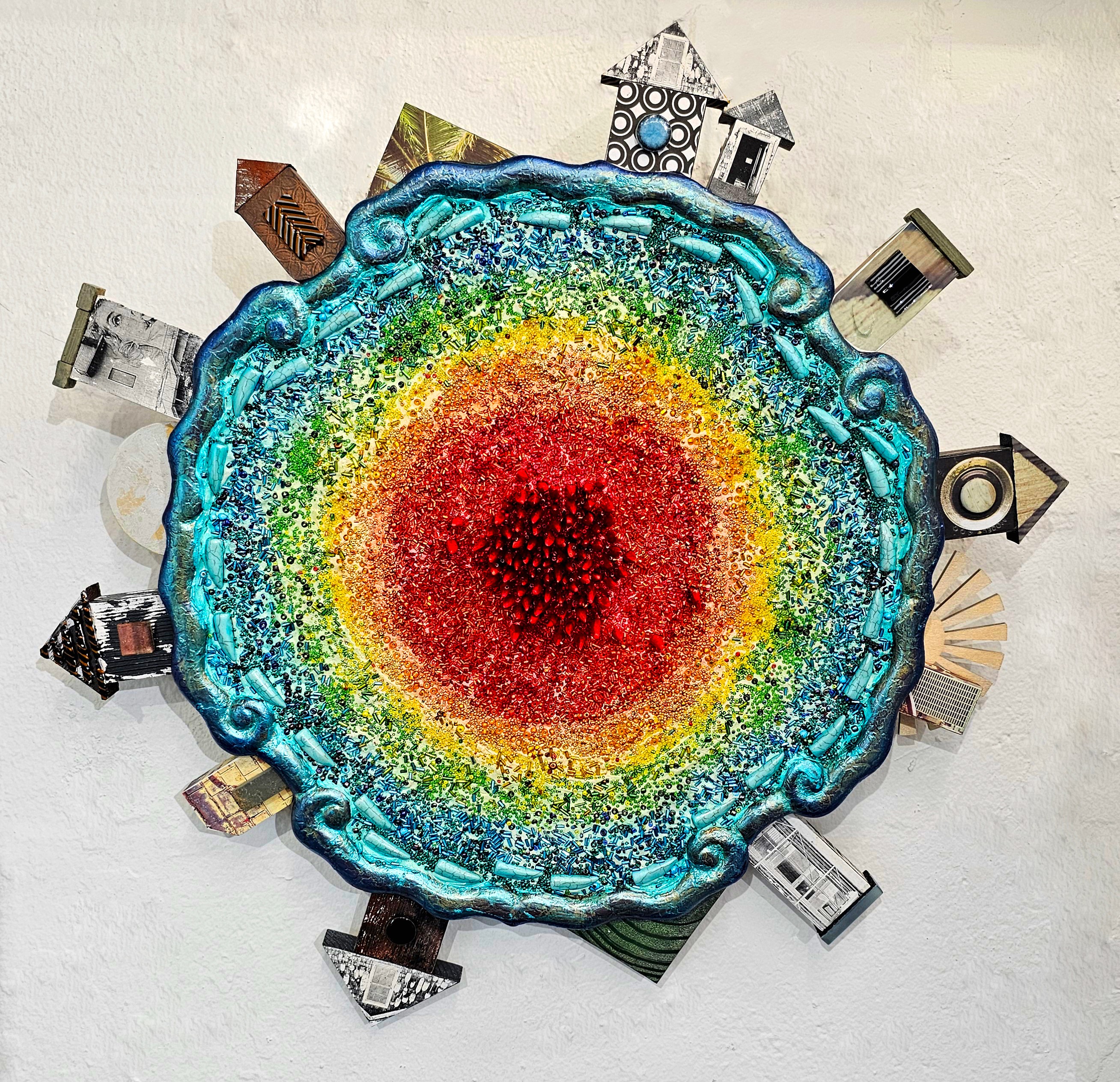 Colorful circular mosaic with small house images around the edge, resembling a rainbow or planet, on a light background.