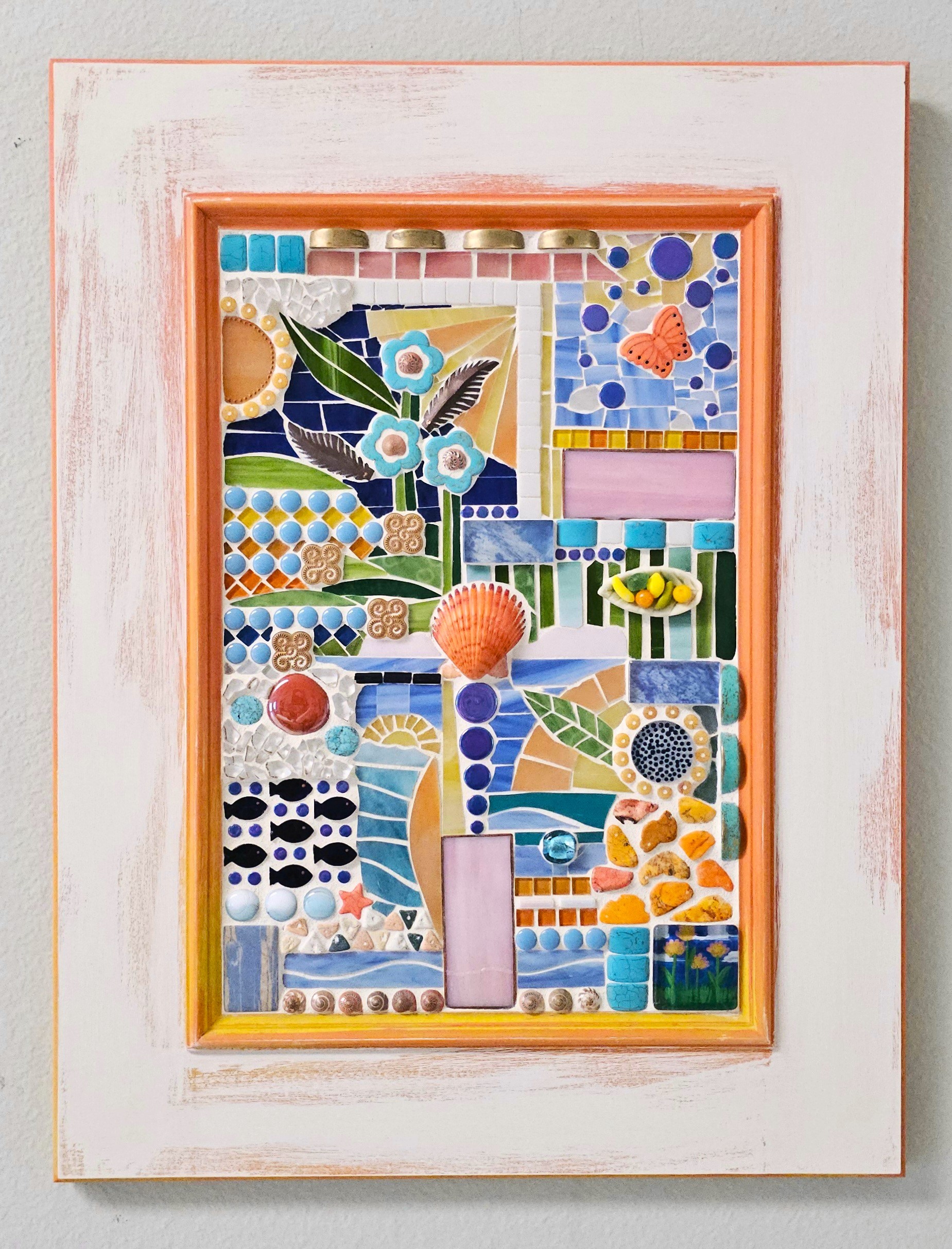 Colorful mosaic artwork with flowers, butterflies, and geometric patterns inside a wooden frame, on a white background.