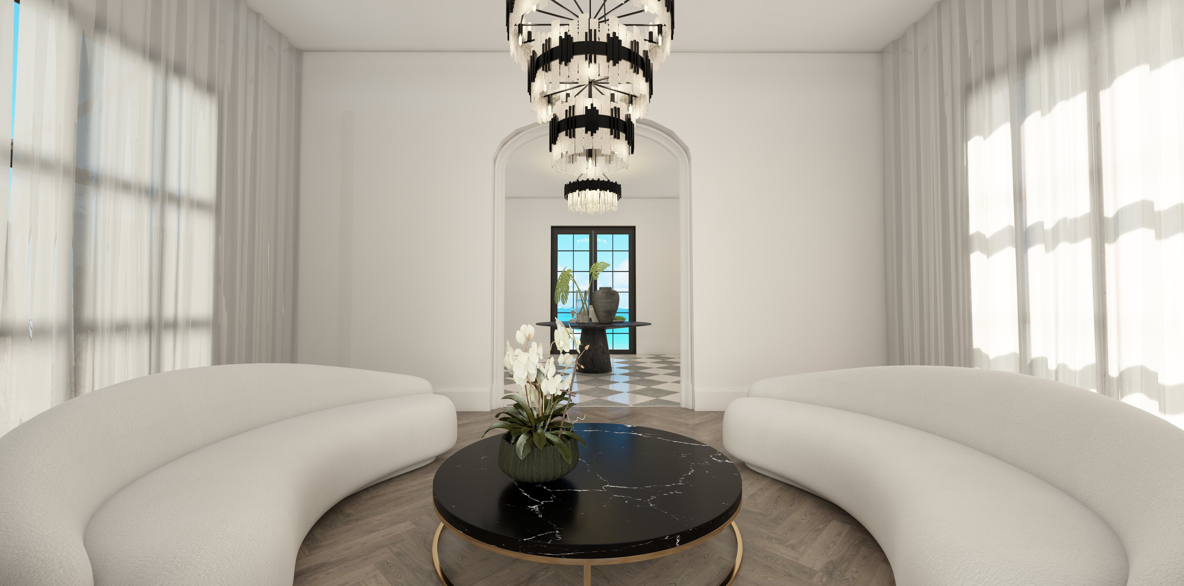 Living room with two curved white sofas, a round black coffee table with a plant, and a windowed door in the background.
