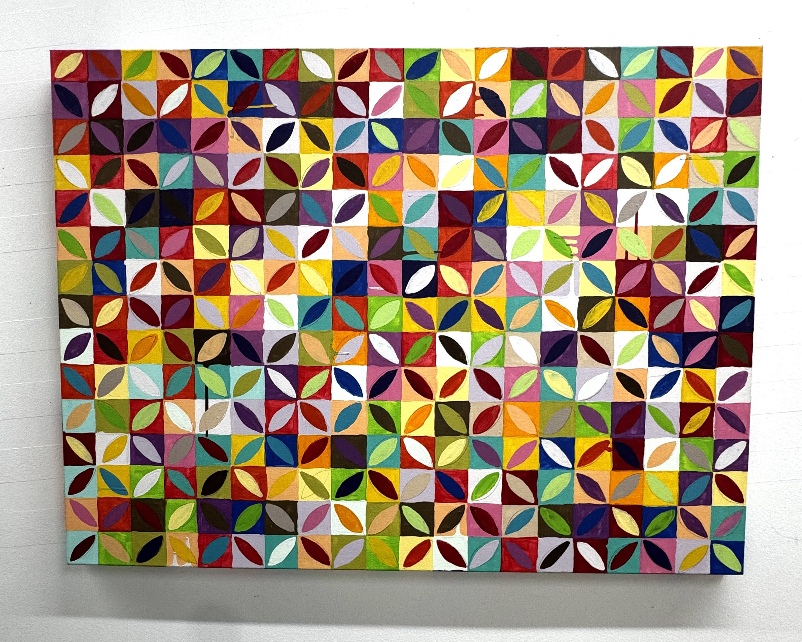 Colorful geometric pattern with circles and triangles on a rectangular surface.