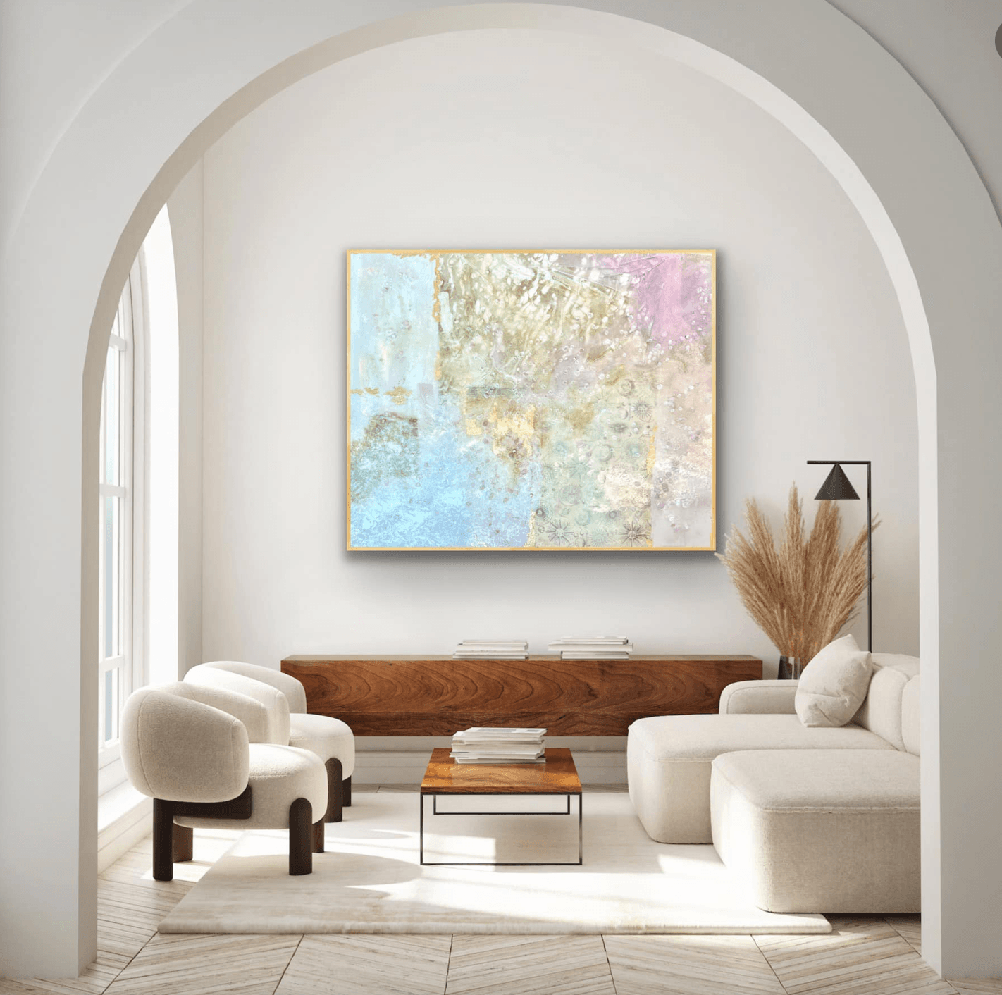 Living room with white chairs, a sofa, a wooden table, and abstract artwork on the wall.