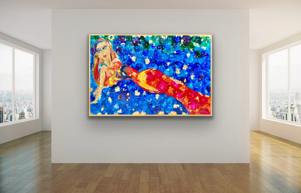 Colorful painting of a mermaid with a red tail on a blue background, displayed on a white gallery wall.