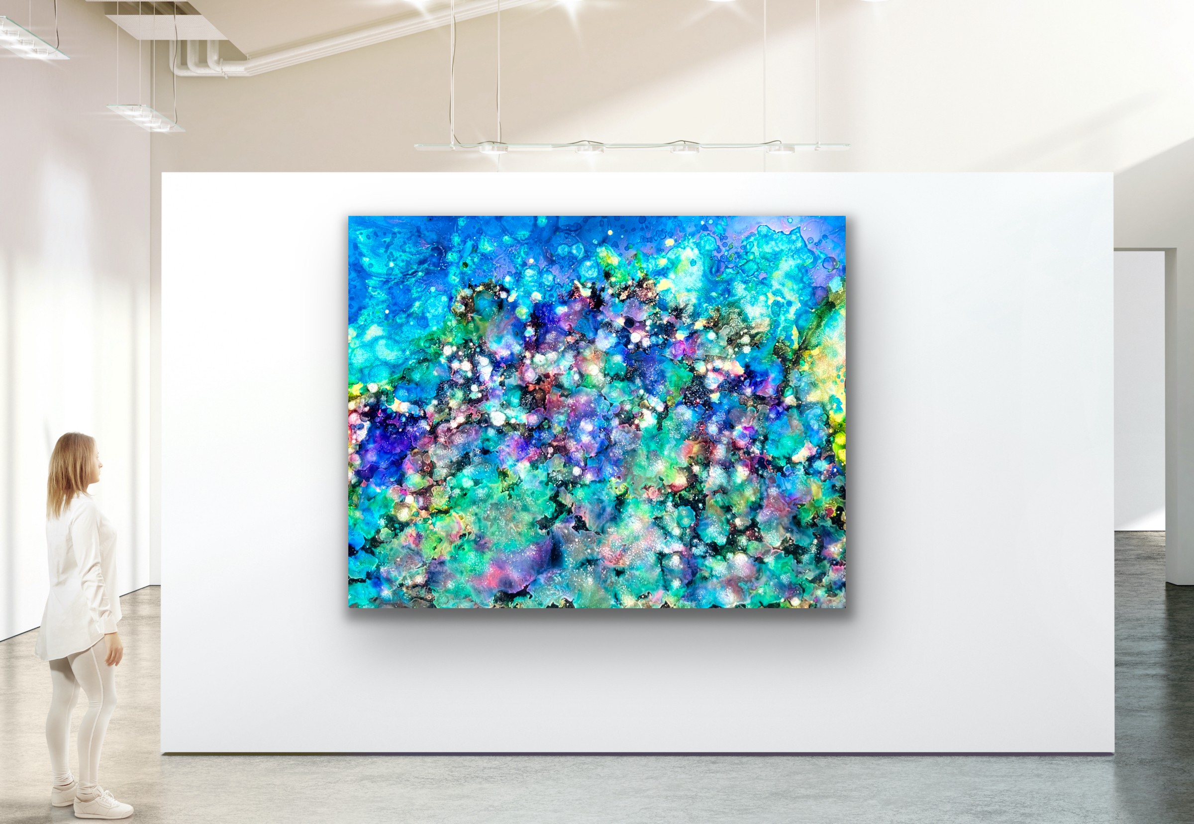 Colorful abstract painting with blue, green, purple, and white splashes on a white wall in an art gallery.