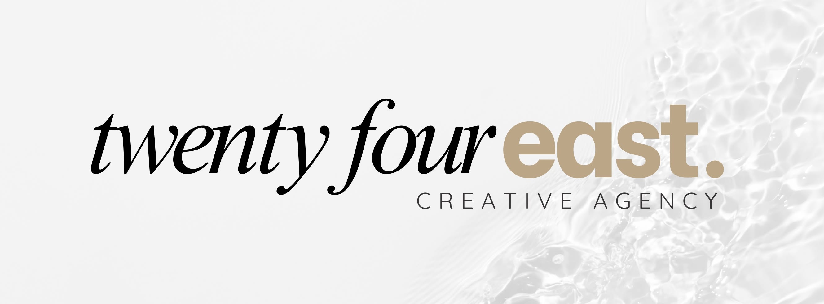 Text reading 'twenty four east. CREATIVE AGENCY' on a light background.