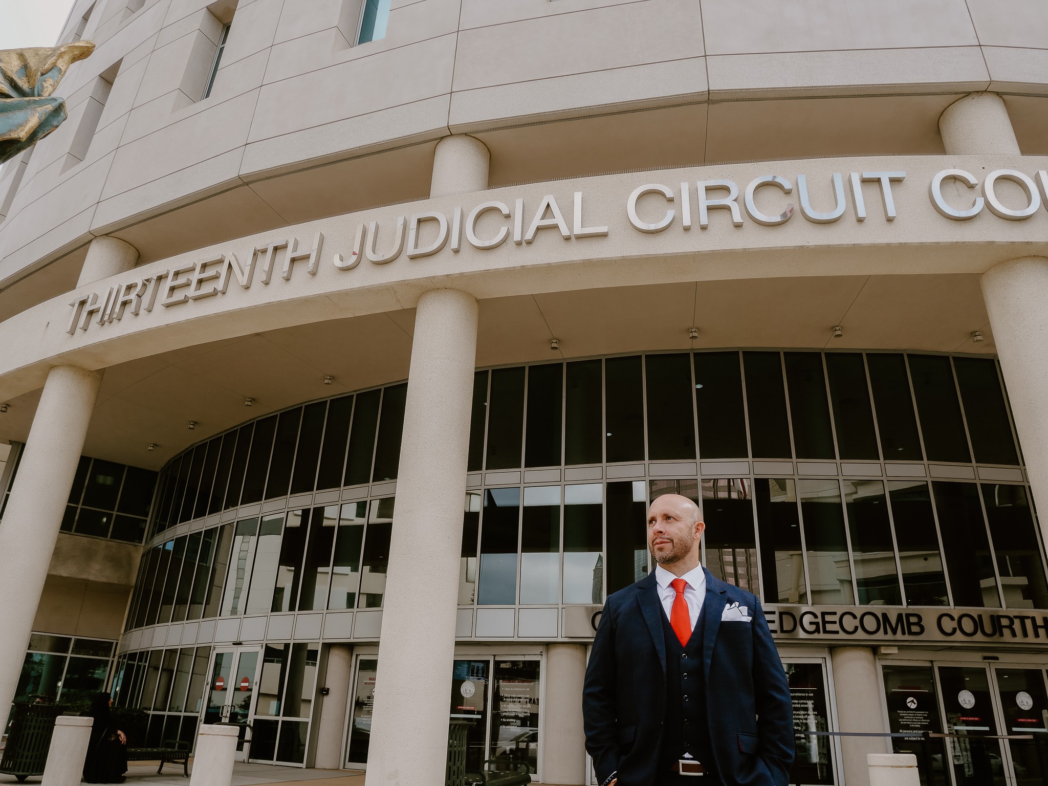 Facade of a courthouse with columns and a sign reading 'Thirteenth Judicial Circuit Court'.