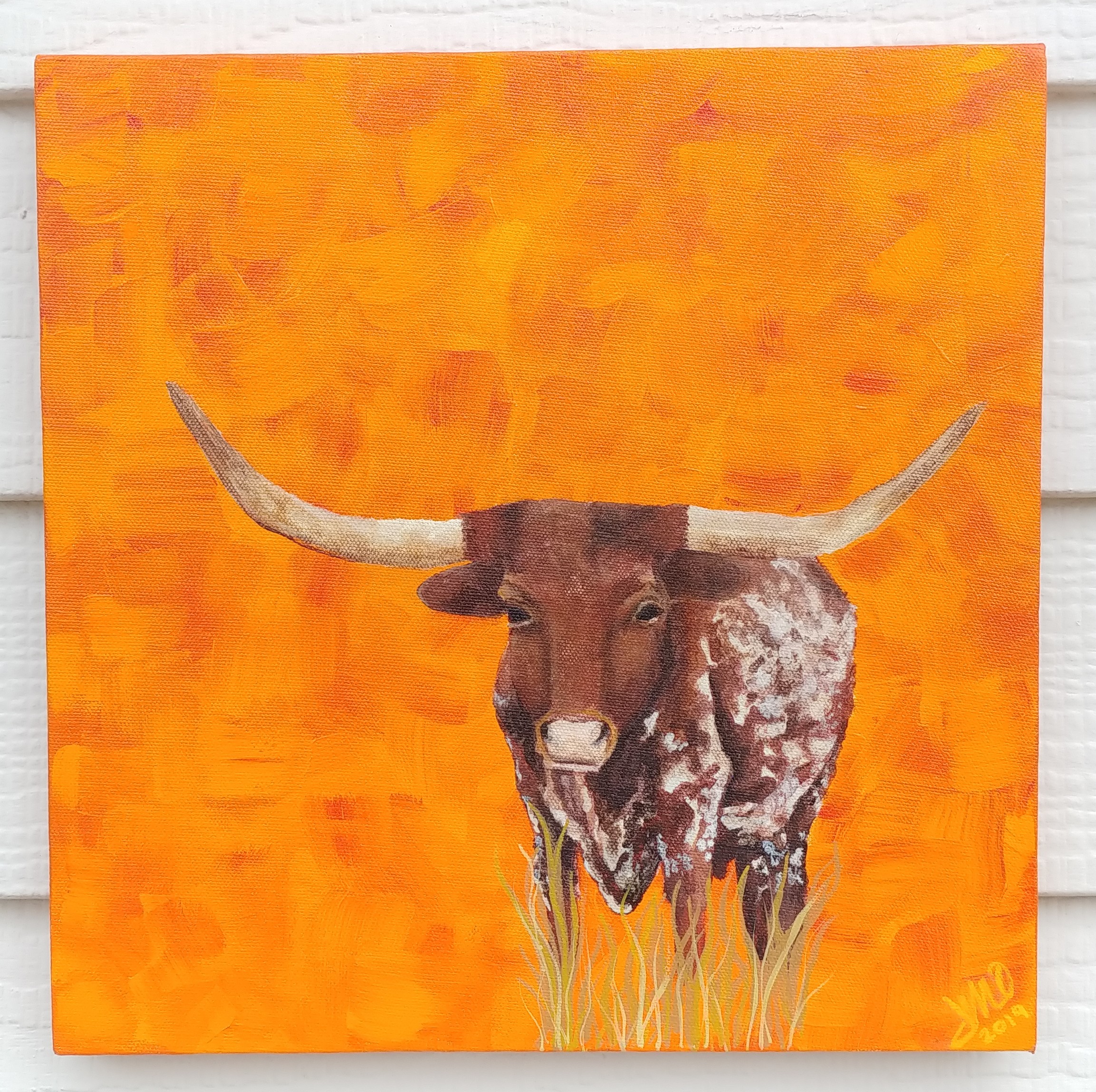 Painting of a longhorn steer with large horns against an orange background.